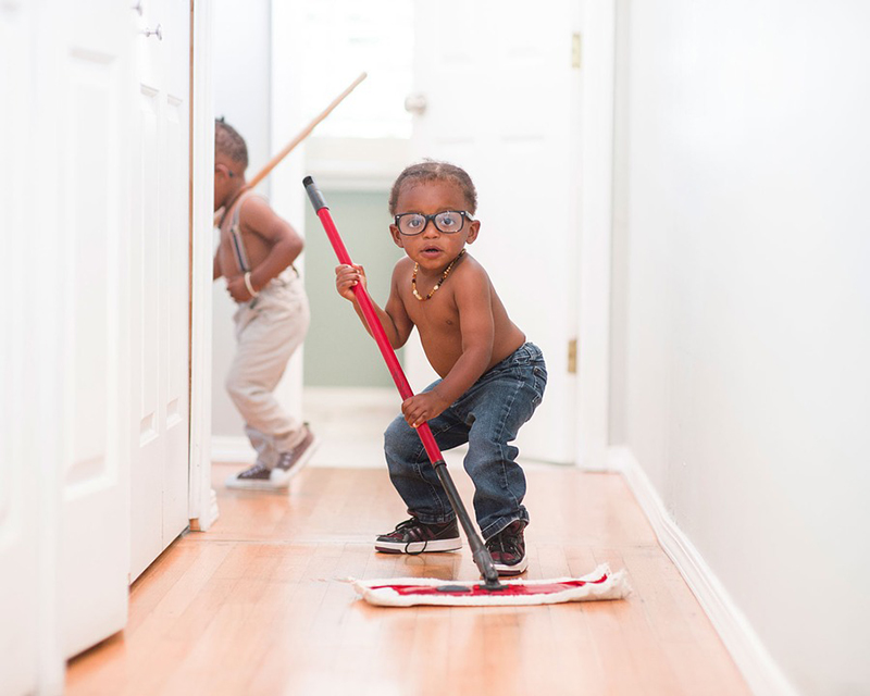 a child holding a mop